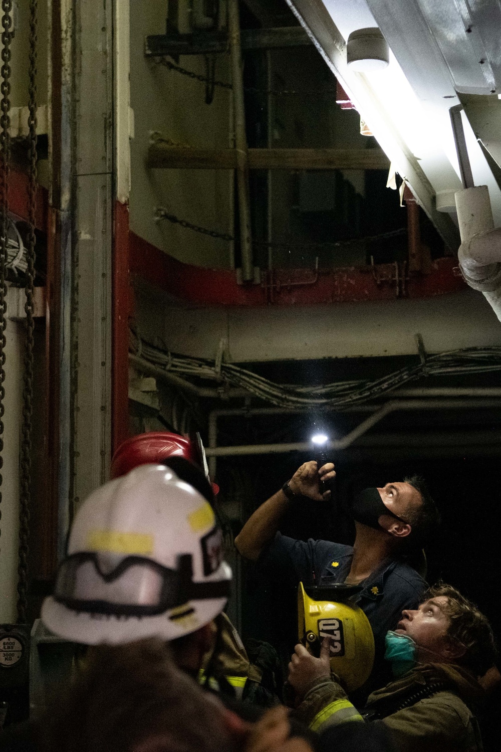 Sailors and federal San Diego firefighters fight fire aboard USS Bonhomme Richard