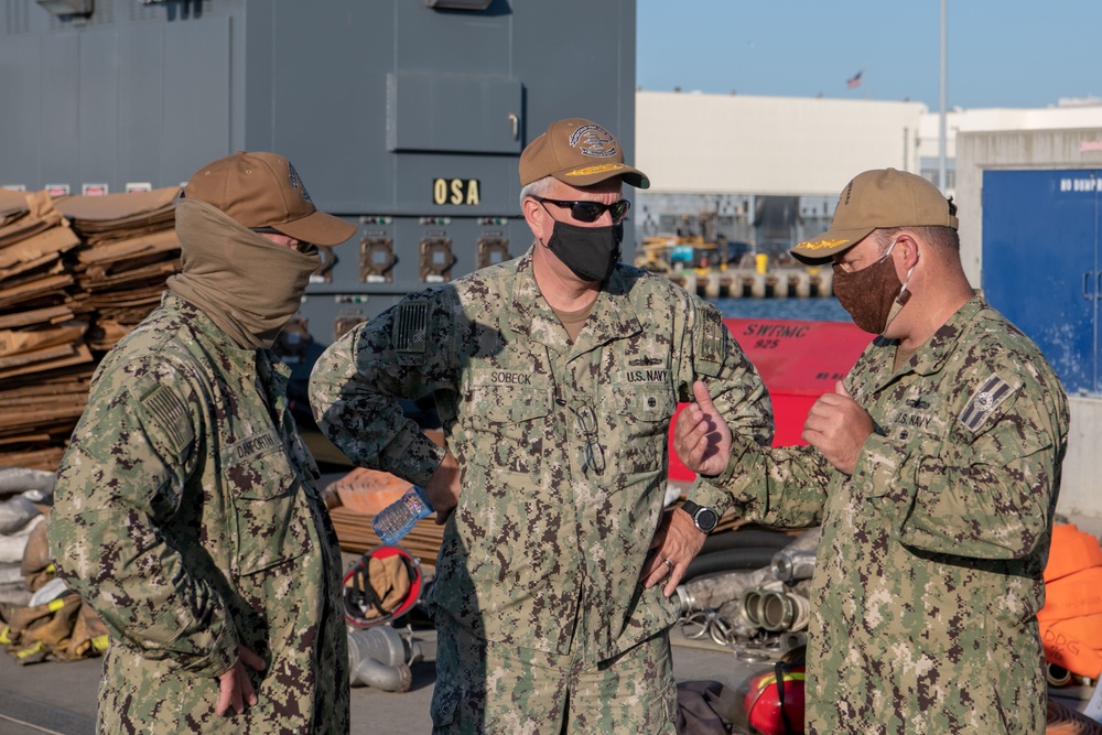 Sailors and federal San Diego firefighters fight fire aboard USS Bonhomme Richard