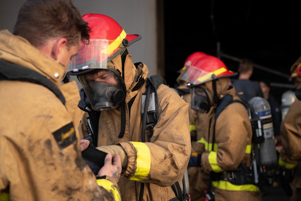 Sailors and Federal San Diego Firefighters fight fire aboard USS Bonhomme Richard