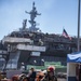 Sailors and federal San Diego firefighters fight fire aboard USS Bonhomme Richard