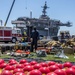 Sailors and federal San Diego firefighters fight fire aboard USS Bonhomme Richard