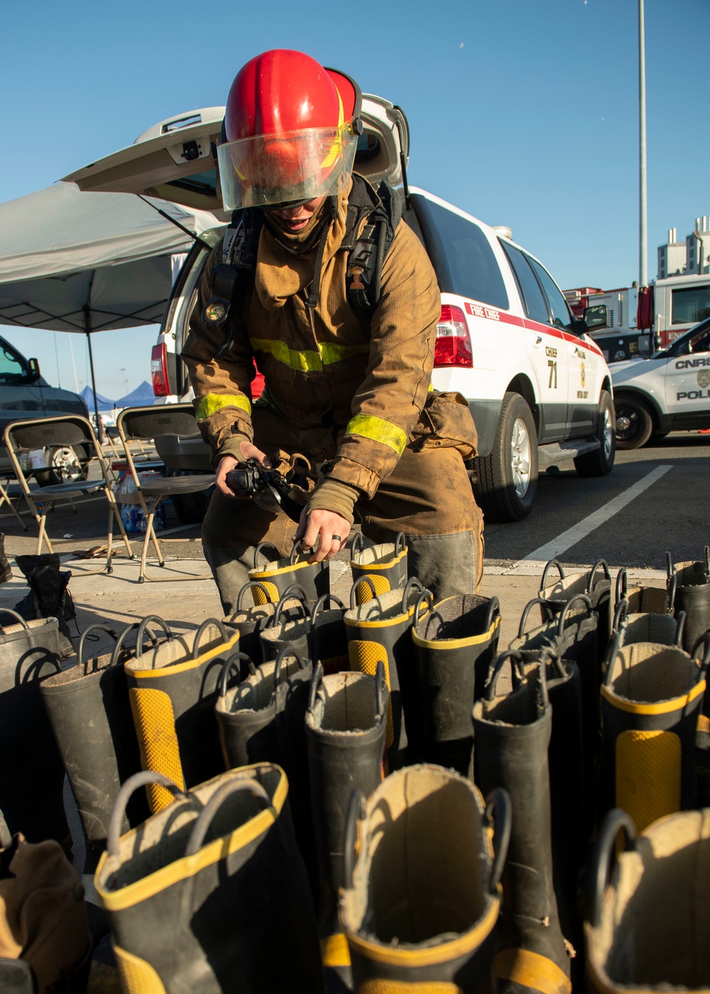 Sailors and federal San Diego firefighters fight fire aboard USS Bonhomme Richard