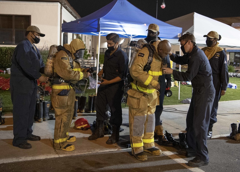 Sailors and federal San Diego firefighters fight fire aboard USS Bonhomme Richard