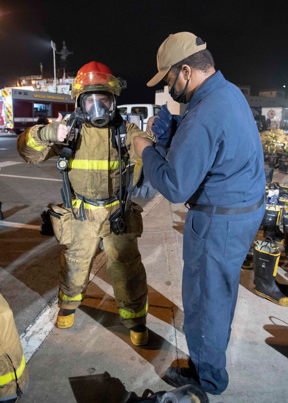 Sailors and federal San Diego firefighters fight fire aboard USS Bonhomme Richard