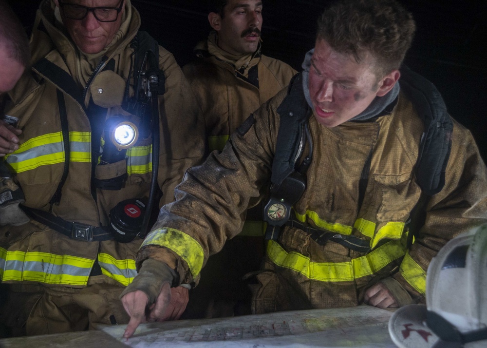 Sailors and Federal San Diego Firefighters fight fire aboard USS Bonhomme Richard