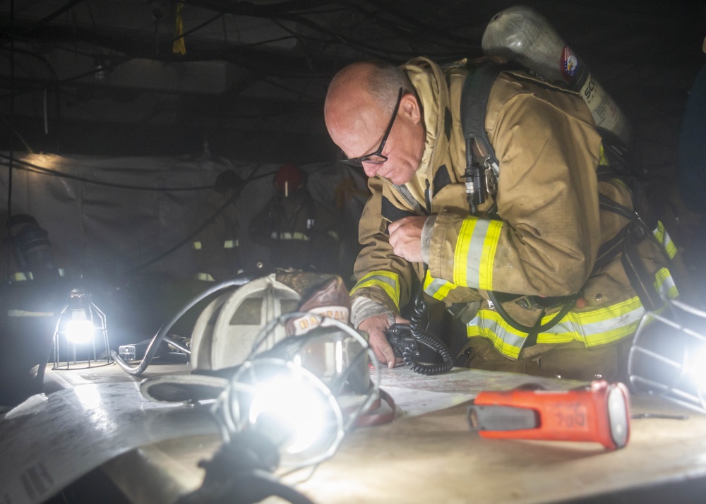 Sailors and Federal San Diego Firefighters fight fire aboard USS Bonhomme Richard