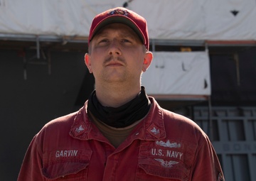 Sailors and federal San Diego firefighters fight fire aboard USS Bonhomme Richard