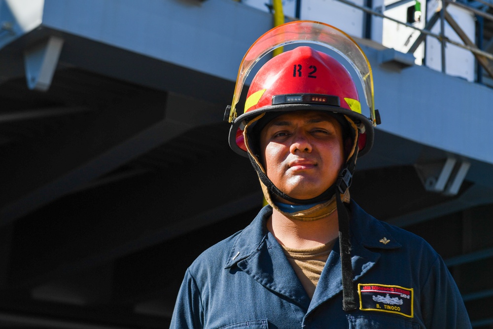 Sailors and federal San Diego firefighters fight fire aboard USS Bonhomme Richard