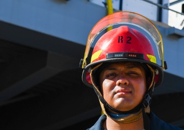 Sailors and federal San Diego firefighters fight fire aboard USS Bonhomme Richard