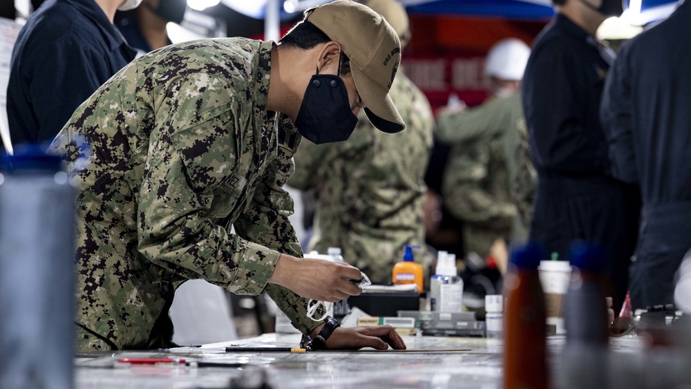 Sailors and federal San Diego firefighters fight fire aboard USS Bonhomme Richard