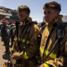 Sailors and federal San Diego firefighters fight fire aboard USS Bonhomme Richard