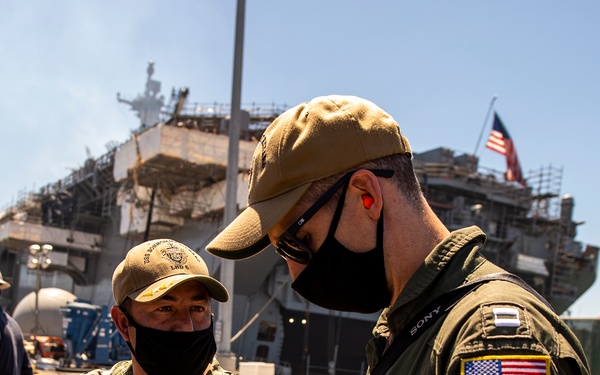 Sailors and federal San Diego firefighters fight fire aboard USS Bonhomme Richard