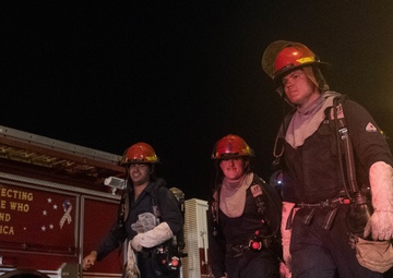 Sailors and federal San Diego firefighters fight fire aboard USS Bonhomme Richard