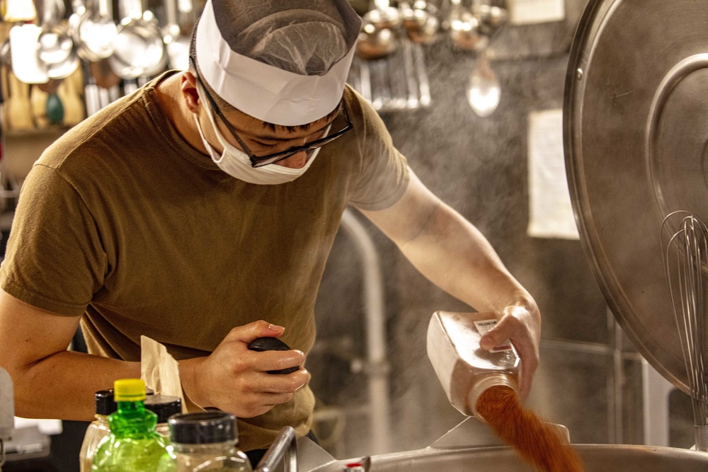 Sailors work in the galley