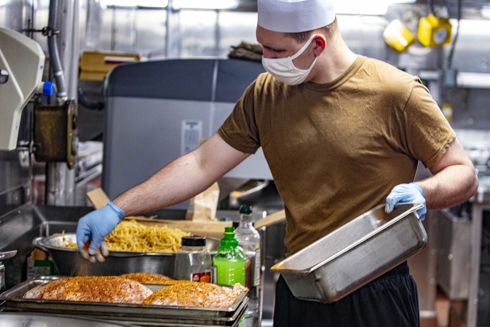 Sailors work in the galley