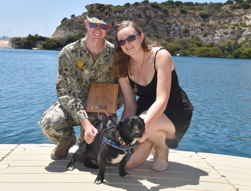 Master-at-Arms 2nd Class Logan Young Reenlists at the Marathi NATO pier facility