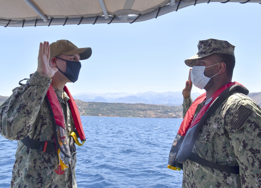 Master-at-Arms 2nd Class Steven Davis Reenlists on a harbor security patrol boat in Souda Bay, Greece