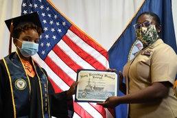 Petty Officer 1st Class Sade Robinson recognizes local high school graduate.