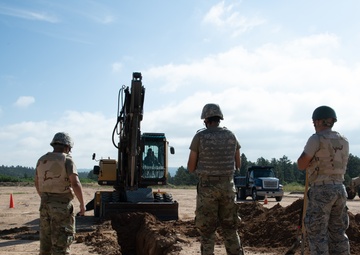 Airmen excavate work site