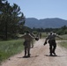 Airmen walk down a path after enduring gas chamber