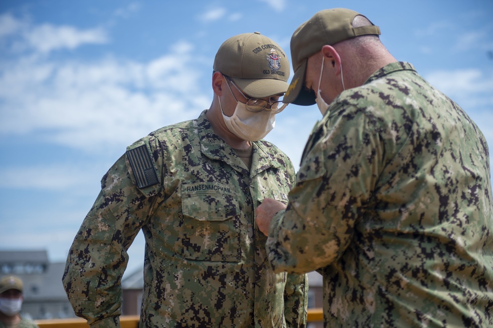 Aviation Electrician’s Mate 3rd Class Zachary Hansenmcphail is promoted by USS Constitution Commanding Officer Cmdr. John Benda