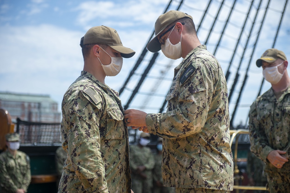 Aviation Machinist Mate 3rd Class Braidon Morrison is promoted by Boatswain’s Mate 1st Class Corey VanBeveren aboard USS Constitution