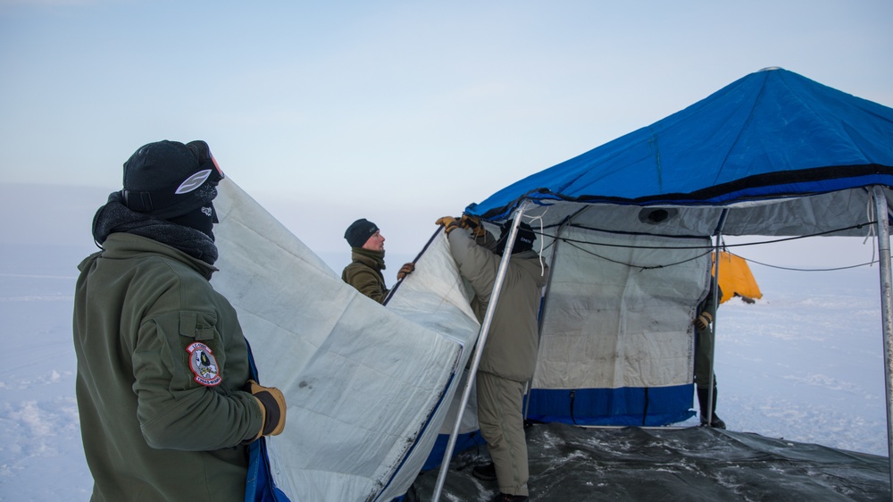 Airmen with the 109th Airlift Wing’s Skiway construction team employ barren land survivial techniques as they erect a polar chief arctic weather shelter at Camp Rockwell during Air National Guard Exercise Arctice Eagle.