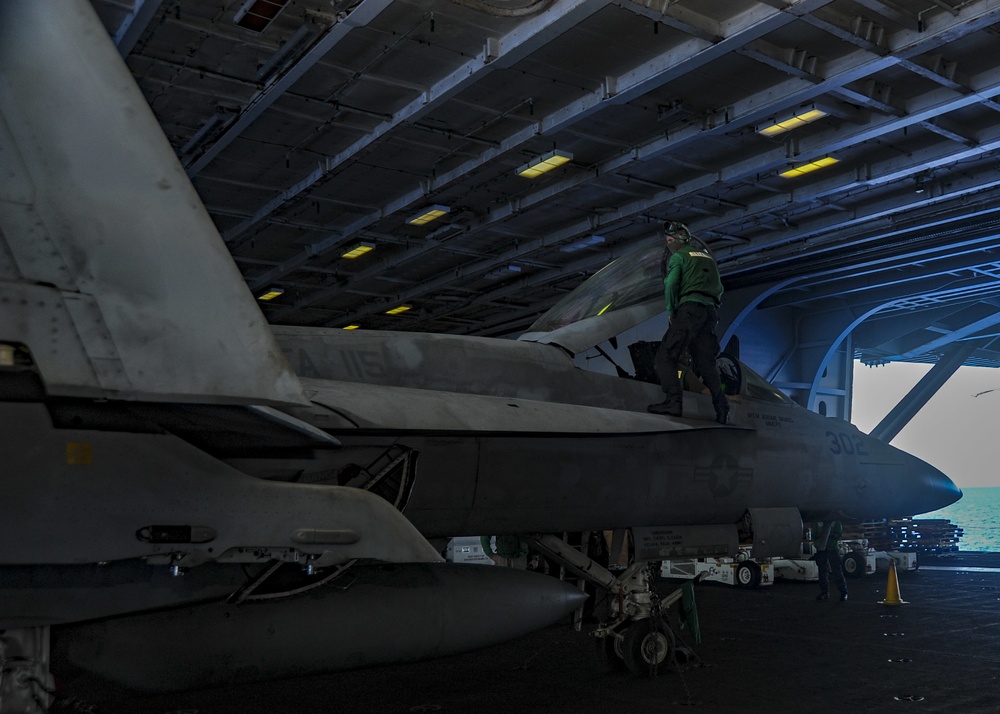 U.S. Navy Sailors Conduct Maintenance on Fighter Jet