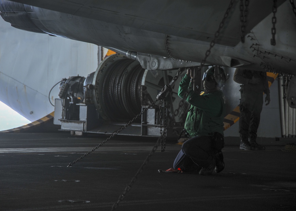 U.S. Navy Sailors Conduct Maintenance on Fighter Jet
