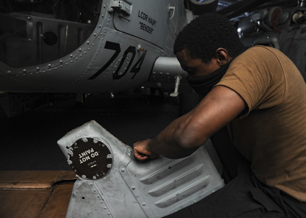 U.S. Navy Sailor Conducts Helicopter Maintenance