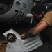 U.S. Navy Sailor Conducts Helicopter Maintenance
