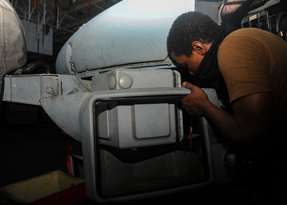 U.S. Navy Sailor Conducts Helicopter Maintenance