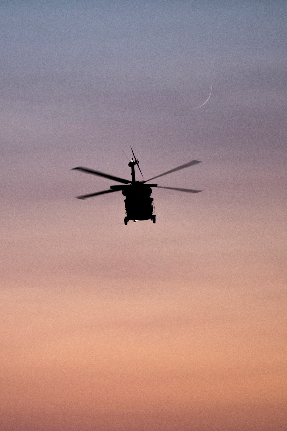 Idaho's Black Hawk helicopter flying in the sunset