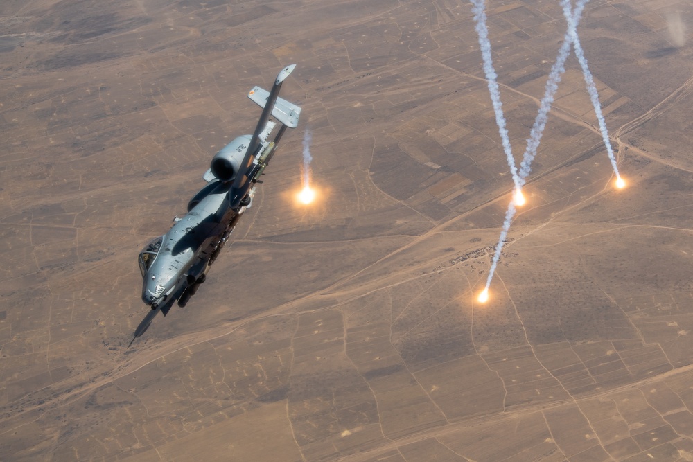 A U.S. Air Force KC-135 Stratotanker refuels A-10 Thunderbolts.