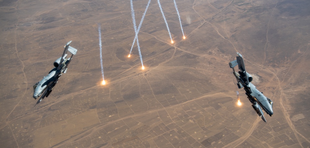 A U.S. Air Force KC-135 Stratotanker refuels A-10 Thunderbolts.