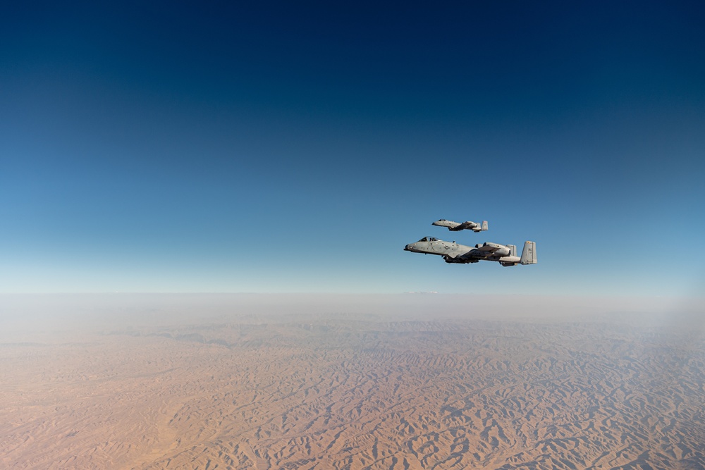 A U.S. Air Force KC-135 Stratotanker refuels A-10 Thunderbolts.