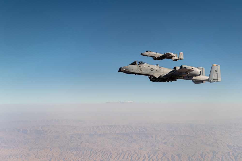 A U.S. Air Force KC-135 Stratotanker refuels A-10 Thunderbolts.