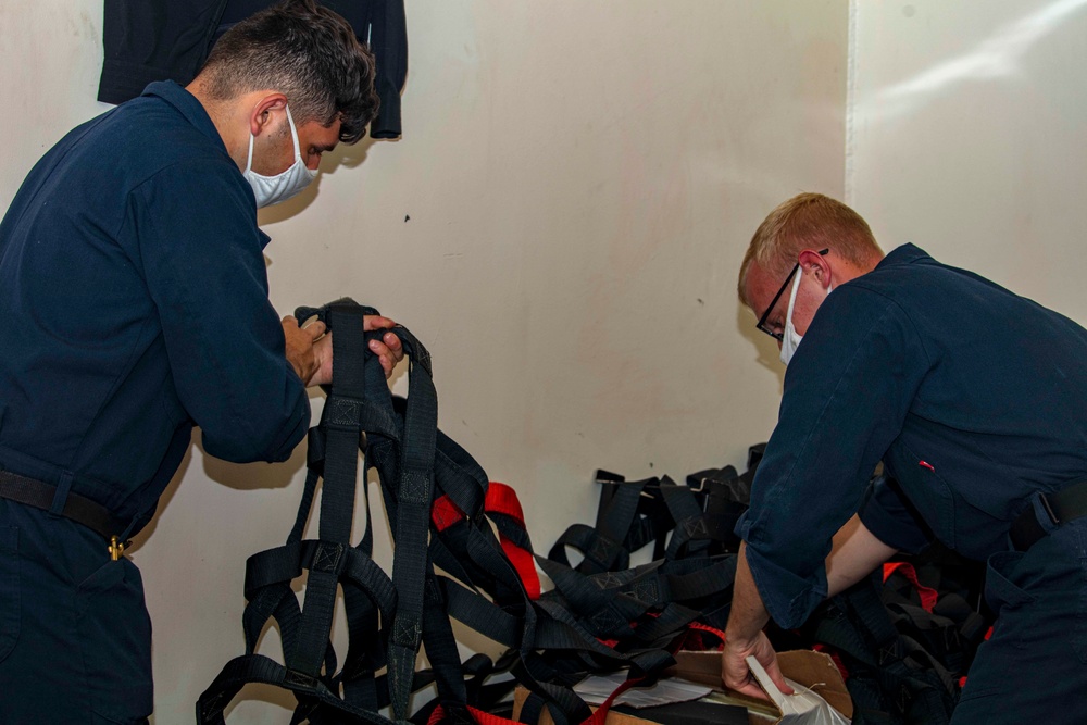 Sailors clean a storeroom