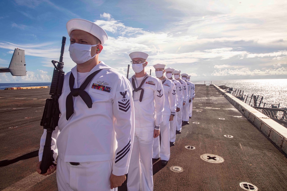 Sailors take part in a burial at sea