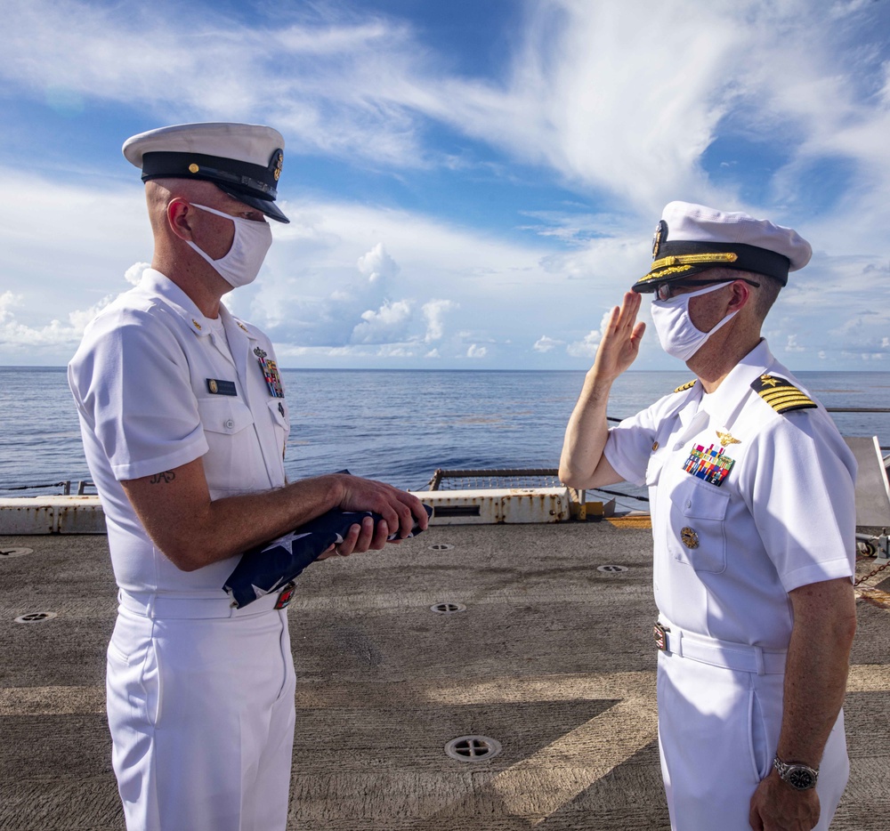 Sailors take part in a burial at sea