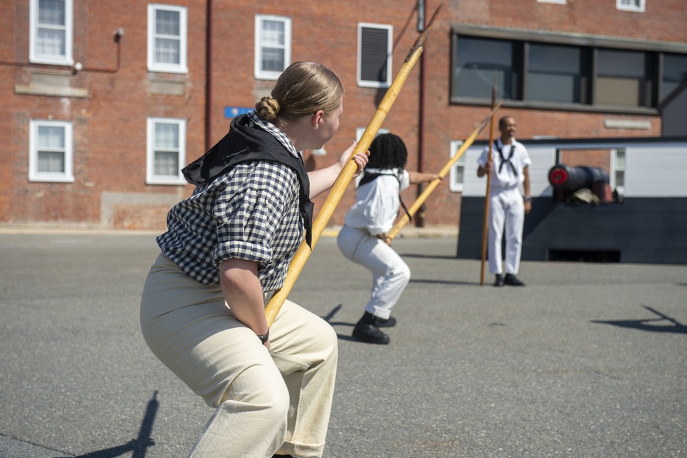 Logistics Specialist Seaman Recruit Patience Jones participates in pike drills with the crew of USS Constitution