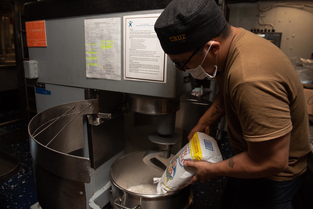 USS Princeton Sailors prepare food in the ship’s galley