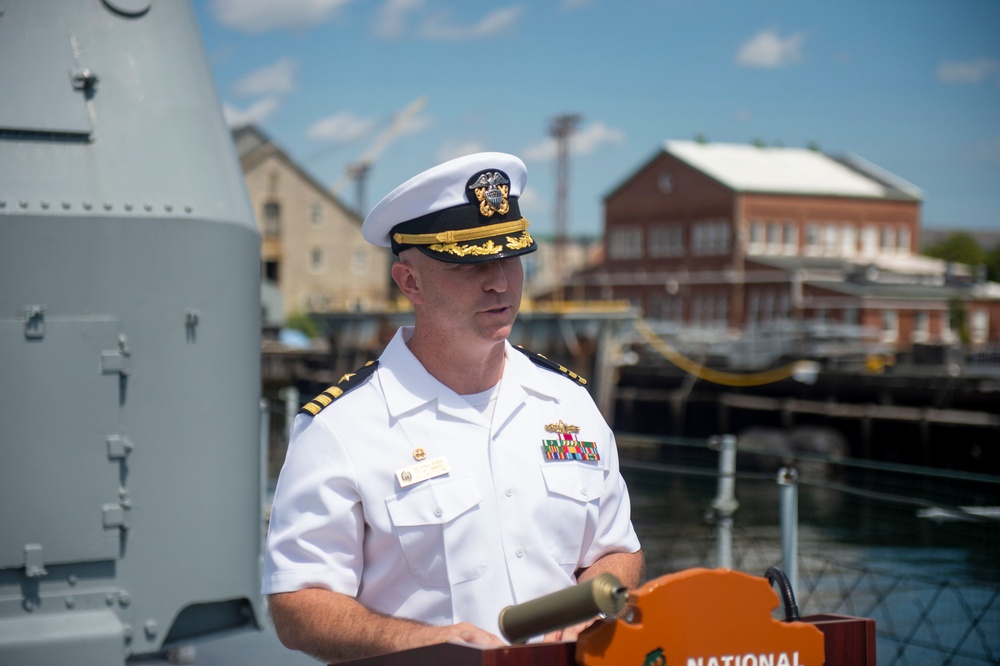 USS Constitution Commanding Officer Cmdr. John Benda gives opening remarks to the 75th anniversary of the kamikaze attacks on USS Cassin Young (DD 793)