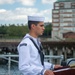 Culinary Specialist 3rd Class Abdon Vivastejada reads the names of sailors that lost their lives during the kamikaze attack aboard the USS Cassin Young