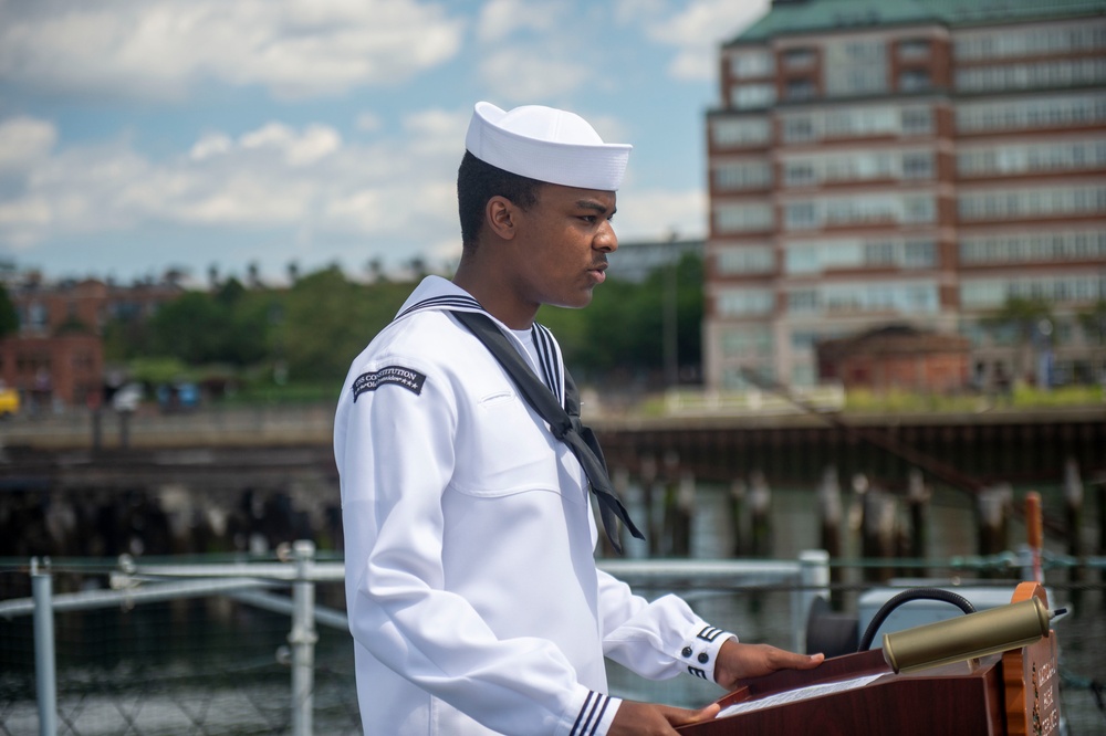 Airman Jabari Shabazz, assigned to USS Constitution, reads the names of sailors that lost their lives during the kamikaze attack aboard the USS Cassin Young (DD 793)