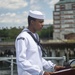 Airman Jabari Shabazz, assigned to USS Constitution, reads the names of sailors that lost their lives during the kamikaze attack aboard the USS Cassin Young (DD 793)