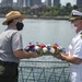 Michael Creasey, Superintendent for the National Parks of Boston and USS Constitution Commanding Officer Cmdr. John Benda perform a reef ceremony for the 75th anniversary of the kamikaze attacks on USS Cassin Young (DD 793)