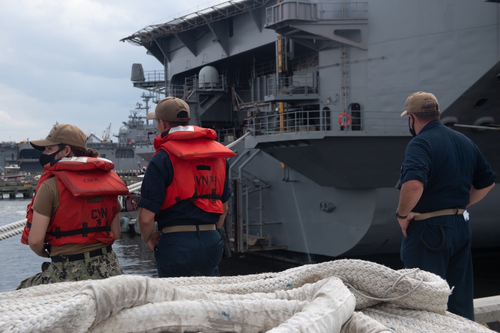 U.S. Sailors add storm lines
