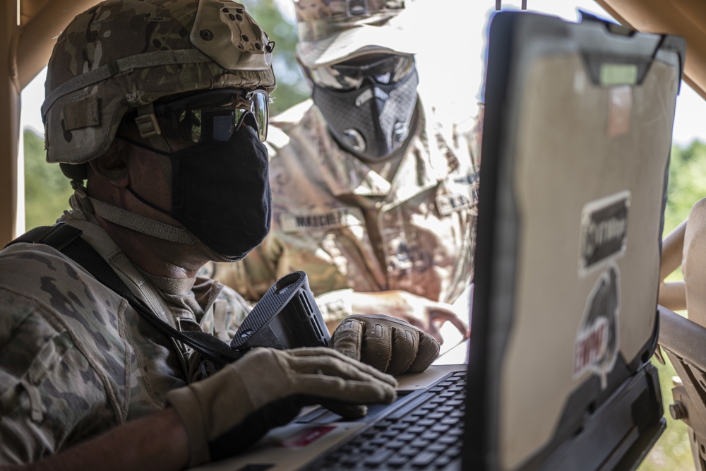 Staff Sgt. Jones works with a cyber warfare trainer of 3rd Infantry Division