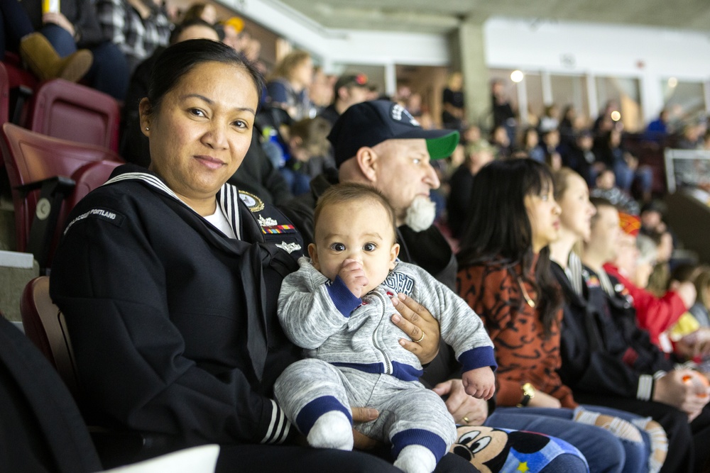 Navy Recruiter readies to conduct oath of enlistment ceremony during Idaho Steelheads match